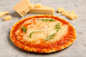 Tasty pizza with parmesan cheese on grey grunge background