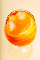 Cocktail Aperol Spritz in glass on a beige background. Aperol Spritz with orange slice and ice...