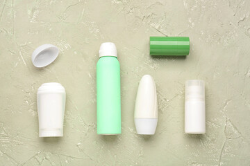 Different deodorant bottles on grunge background