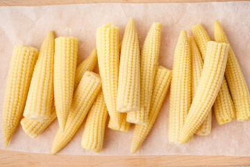 Tasty canned corn cobs on table