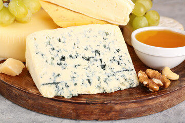 Plate tasty cheese on table, closeup