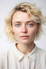 Naklejka premium Blond hair Caucasian young woman portrait. White background studio shot. Generative AI vertical shot