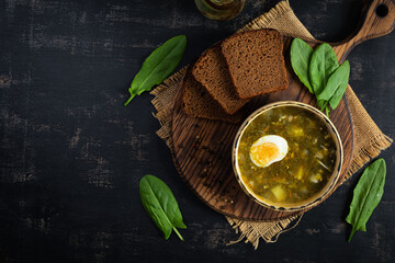 Green soup with sorrel, meat and egg. Traditional sorrel borscht. Top view