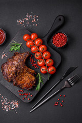 Delicious beef or pork steak on the bone grilled with spices and rosemary