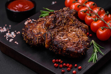 Delicious beef or pork steak on the bone grilled with spices and rosemary