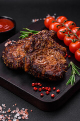 Delicious beef or pork steak on the bone grilled with spices and rosemary