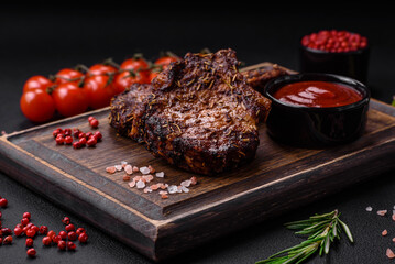 Delicious beef or pork steak on the bone grilled with spices and rosemary