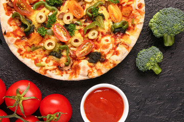 Vegetable pizza with ingredients and cutter on dark background