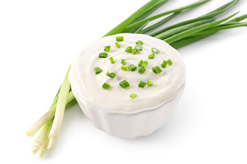 Bowl of tasty sour cream with green onion on white background