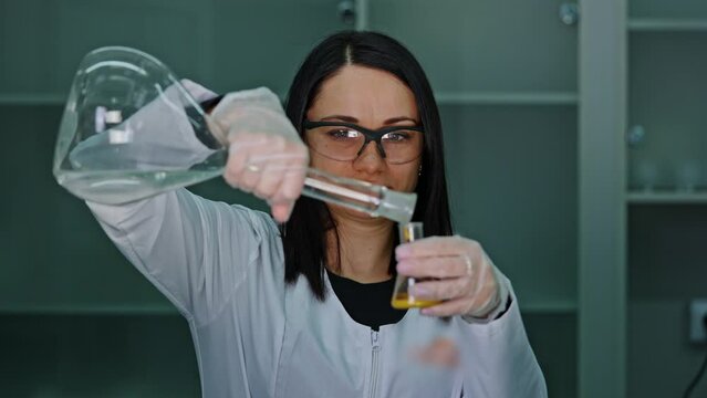 an employee of a technical laboratory holds a test tube with paint in her handsan employee of a technical laboratory holds a test tube with paint in her hands