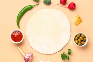 Obraz na płótnie Canvas Raw dough and ingredients for preparing vegetable pie on beige background