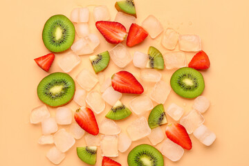 Sliced fresh kiwi with strawberry and ice on orange background