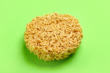 Raw instant noodles on light green background