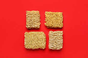 Raw instant noodles on red background