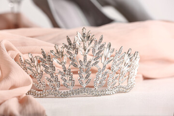 Beautiful tiara with prom dress on white table, closeup © Pixel-Shot