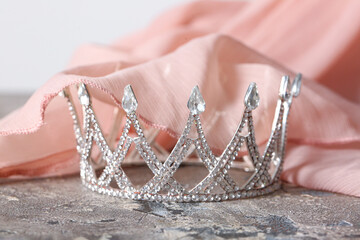 Beautiful crown with prom dress on grunge table, closeup © Pixel-Shot