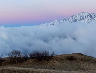 Foto auf Alu-Dibond sunset over clouds in the mountains, North Ossetia, Caucasus, Russia © Павел Ващенков
