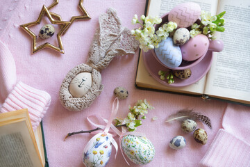 A cup of hot coffee on a festive Easter table with colored eggs.