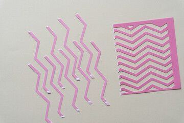 pink paper stripes with a strong zig zag element on blank paper