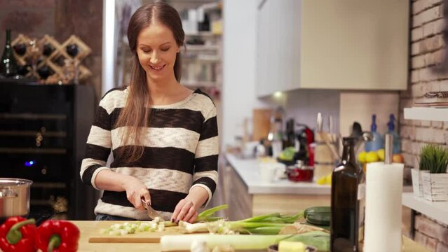 Young woman cooking in kitchen at home, healthy eating.
