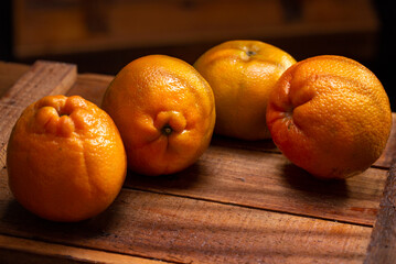 oranges on wooden table in sunset