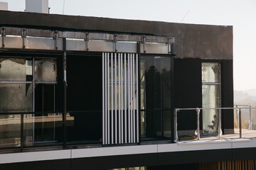 the facade of a new modern house , in the photo balconies and windows of the building close-up