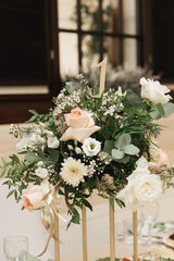Beautiful flower arrangements decorate the tables for the event, table numbering