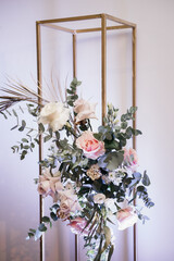 Wedding decor, floral arrangement of roses and eucalyptus decorates the event