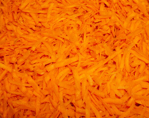 Orange background. Sliced carrot. Salad.