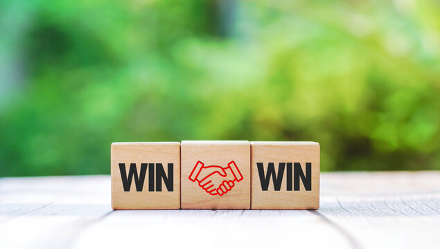 Wooden cube with the word win win with handshake icon, Win win situation in business strategy. and win-win-situation.        