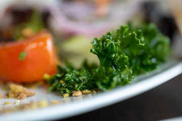 vegetables, small tomato, cabbage and nuts delicious Italian food style dish on white plate