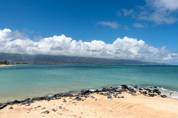 The view from the beach on Hawaiian coastline with windsurfers