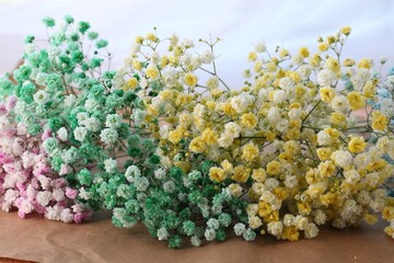 Beautiful gypsophila flowers on kraft paper, closeup