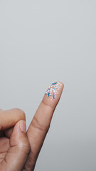 Climate change idea. Close up microplastics lay on female people finger hand. it's very small.