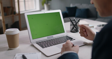 Green screen template for video chat. Businessman using laptop having teleconference with employees, talking and gesturing 