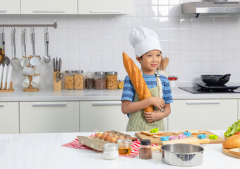 Little boy holding long loaf bread or baguette.