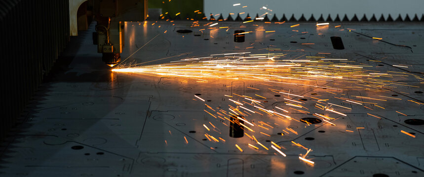 CNC machine. Laser cutting of metal. Sparks.