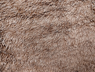 The striped brown abstract background looks cool, the background is made of fluffy fabric