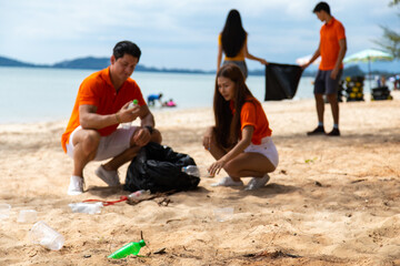 Fototapeta na wymiar Earth day. volunteer collects garbage. Diverse people man and woman team cleaning up the beach