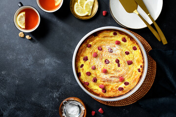 Fresh baked sweet Filo Pastry pie with raspberry and powdered sugar. Black background, top view