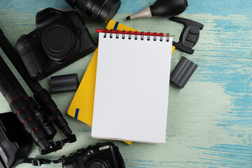 Mix of old cameras, equipment and accesseries on blue wooden desk background, photography concept