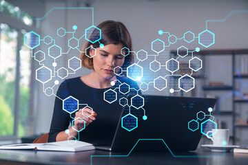 Pensive attractive beautiful businesswoman in formal wear working on laptop at office workplace in background. Notebook, table. Concept of business education, blockchain cryptocurrency technology.