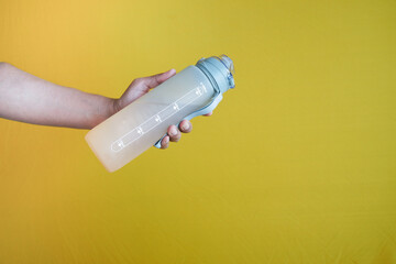 holding a water bottle close up 