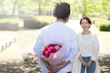 Men giving gifts for Mother's Day, wedding anniversaries, birthdays, etc. Copy space available