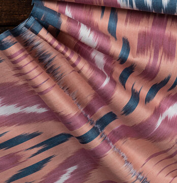 Uzbek pink and blue adras textile background.