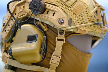 Helmet with headphones for an army radio on a mannequin. Portable military communications