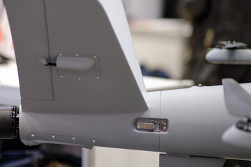 Fototapeta premium A military unmanned aerial vehicle armed with hand grenades to take out enemy soldiers and army targets.