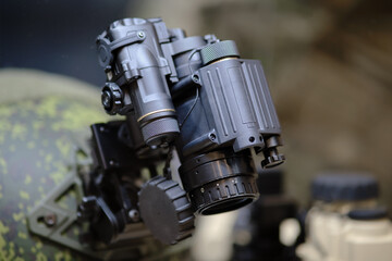 Army binoculars with night vision on a soldier's helmet. Optical device on a military helmet for tracking in war
