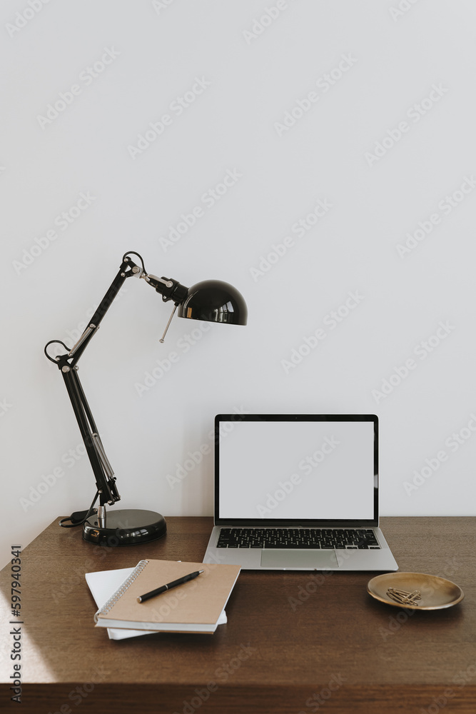 Wall mural minimalist home office desk workspace with laptop computer, lamp on table. front view copy space bla