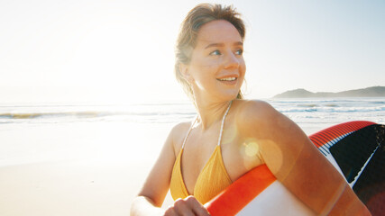 Woman surfer walks with surfing board on the tropical beach